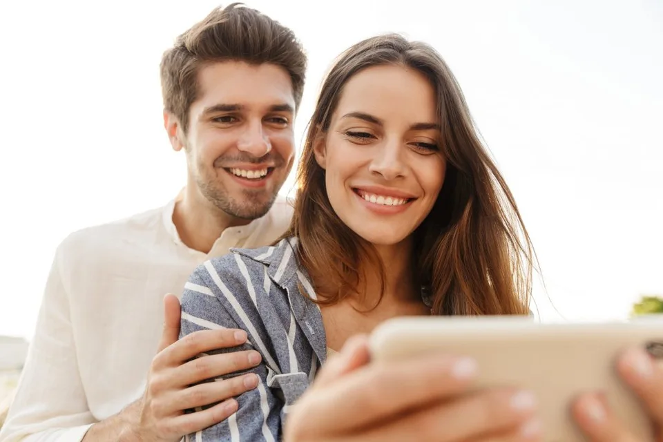 Happy couple smiling confidently after straight teeth treatment