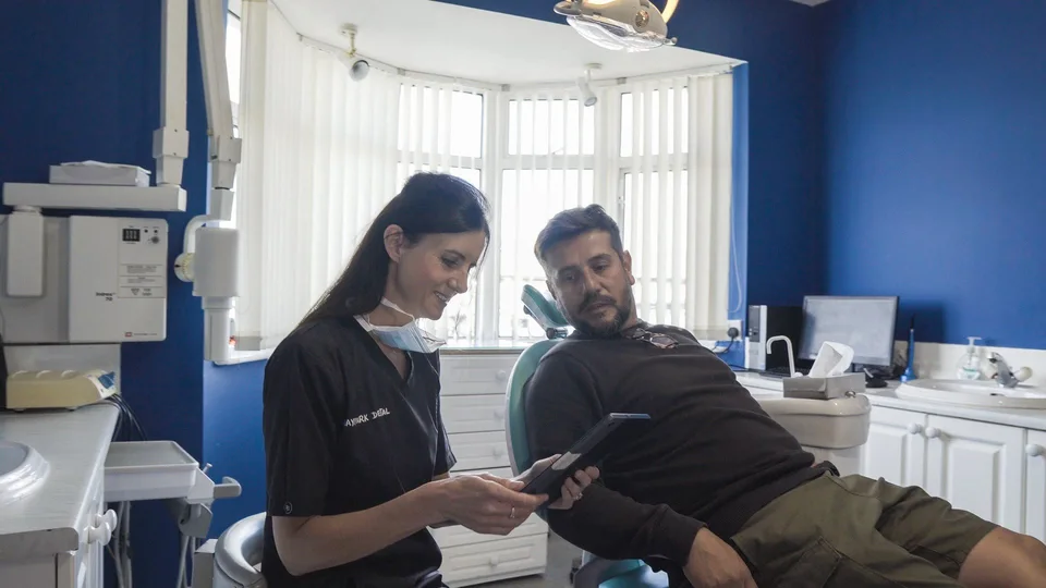 Dentist discussing Invisalign Dublin treatment with patient in clinic